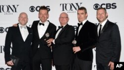 Simon Stephens, second right, Michael Morris, second left, and the crew accept the award for best play for "The Curious Incident of the Dog in the Night-Time" at the 69th annual Tony Awards at Radio City Music Hall on Sunday, June 7, 2015, in New York.