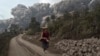 A villager runs as Mount Sinabung erupt at Sigarang-Garang village in Karo district, Indonesia's North Sumatra province, February 1, 2014.