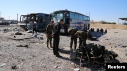 Iraqi security forces inspect the site of a blast where a suicide bomber detonated his explosives-laden ambulance in Iraq's holy city of Samarra, north of Baghdad, Nov. 6, 2016. 