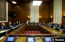 FILE - Asaad Al-Zoubi (R), head of the Syrian opposition delegation, and Salim al-Muslat (2nd R), spokesman for the High Negotiations Committee (HNC), attend peace talks with U.N. mediator for Syria Staffan de Mistura (2nd L) at the United Nations in Geneva.