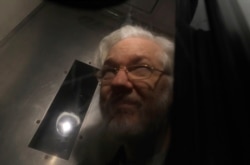 Wikileaks founder Julian Assange leaves in a prison van after appearing at Westminster Magistrates Court for an administrative hearing in London, Jan. 13, 2020.