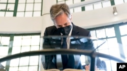 Secretary of State Antony Blinken signs a condolence book at the August 7 Memorial in Nairobi, Kenya, Nov. 17, 2021, which is one of the sites of the 1998 United States embassy bombings that left hundreds of people dead.