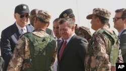 Jordan's King Abdullah II, center, and U.S. Vice President Joe Biden, left, visit a joint Jordanian-American training center at Zarqa, northeast of Amman, Jordan, March 10, 2016.