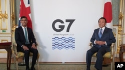 Britain's Chancellor of the Exchequer Rishi Sunak, left, meets with Japanese Deputy Prime Minister and Finance Minister Taro Aso, in London, June 3, 2021, for a bilateral meeting ahead of the G-7 Finance Ministers meeting on Friday.