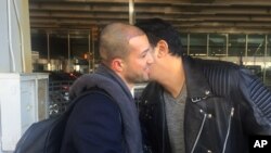 Ammar Alnajjar, left, shakes hands with his cousin, Fahd Alfakih, after coming into New York's JFK International Airport on a flight from Istanbul, Turkey, Feb. 4, 2017. 