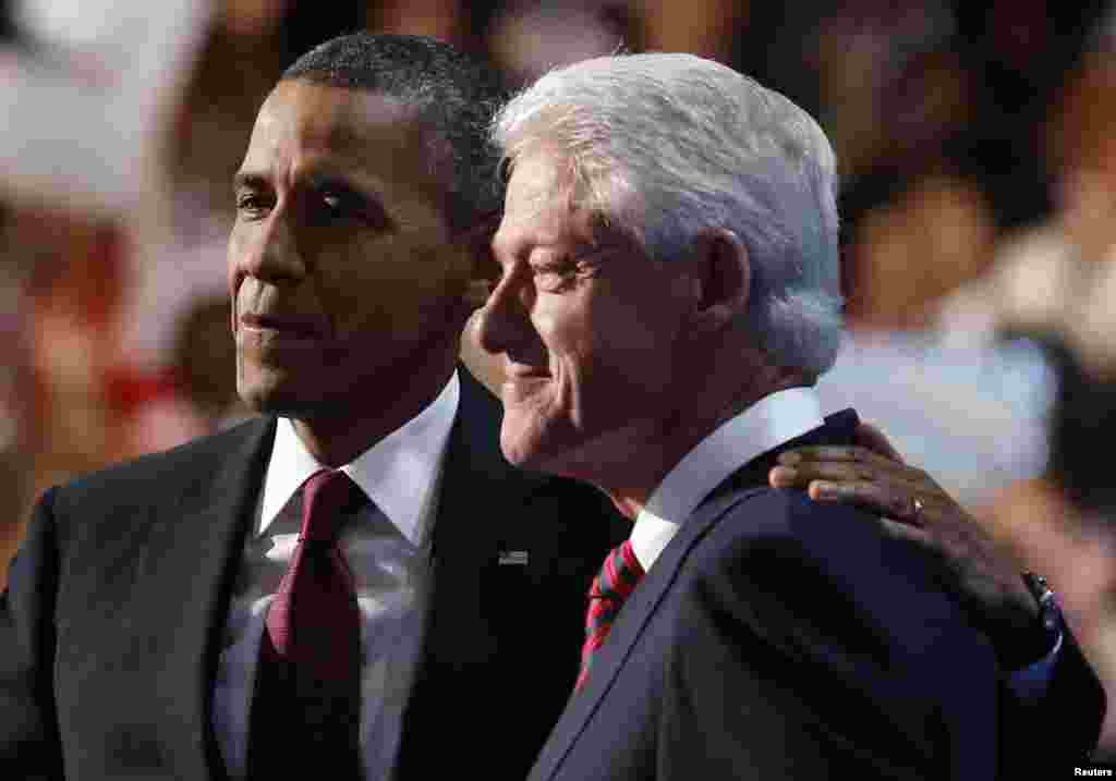 U.S. President Barack Obama (L) embraces former President Bill Clinton onstage after Clinton nominated Obama for re-election during the second session of Democratic National Convention in Charlotte, North Carolina, September 5, 2012