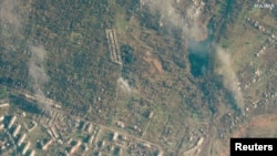 A satellite view shows a smoldering building, in Soledar