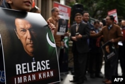 FILE - A supporter of Pakistan Tehreek-e-Insaf party and jailed former Prime Minister Imran Khan holds a placard during a protest rally in Sydney on Aug. 4, 2024, demanding Khan's release from the jail.