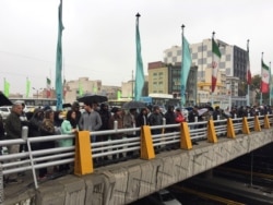 FILE - People stand in the street to protest the increased gas price in Tehran, Iran, Nov. 16, 2019.