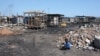 FILE - A child is playing near piles of refuse in the Agbogbloshie neighborhood of Accra, Ghana, Oct. 27, 2014. (Chris Stein/VOA)