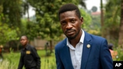 Uganda's leading opposition challenger Bobi Wine walks back to his residence after giving a press conference outside Kampala, Uganda, Jan. 15, 2021, one day after Ugandans went to the polls. 