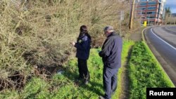 NTSB investigators search the area where a mobile phone of a passenger was found, after an Alaska Airlines Flight 1282 Boeing 737 MAX 9 jet lost a panel mid-flight last week, in Beaverton, Oregon, Jan. 7, 2024 in this image obtained from social media. (Sean Bates via REUTERS)
