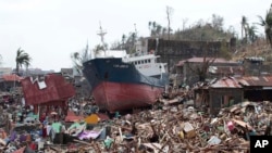 A ship lies on top of damaged homes after it was washed ashore in Tacloban city, Leyte province, central Philippines, Nov. 10, 2013.