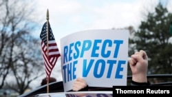 Demonstrators in a car caravan demand the Board of State Canvassers certify the results of the election in Lansing, Michigan, November 23, 2020.