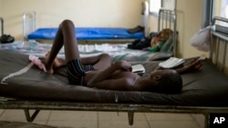 A child suffering from the Ebola virus receives treatment at Makeni Arab Holding Centre in Makeni, Sierra Leone, Saturday, Oct. 4, 2014. Makeni is one of three districts recently quarantined by the government. (AP Photo/Tanya Bindra)
