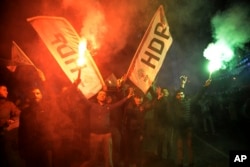 People's Democratic Party supporters (HDP) celebrate after the announcement of preliminary results of the local elections, in Diyarbakir, Turkey, Sunday, March 31, 2019.