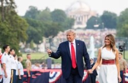 FILE - President Donald Trump and first lady Melania Trump host the 2020 "Salute to America" event in honor of U.S. Independence Day, on the South Lawn of the White House, in Washington, July 4, 2020.