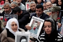 FILE - Selahattin Demirtas (C), co-leader of Turkey's pro-Kurdish Peoples' Democratic Party (HDP), attends a gathering of "Saturday Mothers" at Galata Sarai Square in Istanbul, Oct. 31, 2015, on the eve of the country's general election.