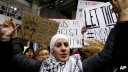 Demonstrators converge outside Terminal 5 of O'Hare airport in Chicago, Jan. 29, 2017.
