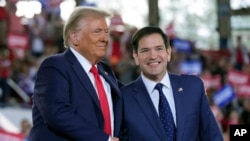 FILE - Donald Trump, left, greets Senator Marco Rubio during a campaign rally in Raleigh, North Carolina, Nov. 4, 2024. Trump, now president-elect, has tapped Rubio to become U.S. secretary of state.