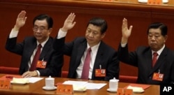 FILE – In 2012, then Vice President Xi Jinping, center, and Jia Qinglin, right, attend a committee meeting. Relatives of both men have been linked to offshore holdings. At left is He Guoqiang.
