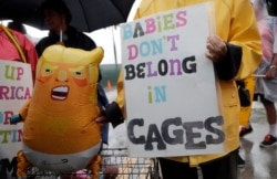 Protesters hold an inflatable doll outside of the Homestead Temporary Shelter for Unaccompanied Children, June 16, 2019, in Homestead, Fla. A coalition of religious groups and immigrant advocates said they want the Homestead detention center closed.