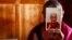 FILE - A monk holds a picture of Tibetan spiritual leader Dalai Lama inside of his room at Labrang Monastery in Xiahe county, Gansu Province.