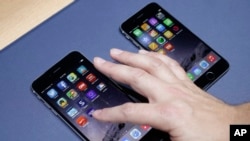 The iPhone 6 plus, at left, and iPhone 6 are displayed on Sept. 9, 2014, in Cupertino, Calif.