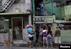 People wager money on "Los Animalitos" (or the Little Animals) betting game on the outskirts of Caracas, Venezuela, October 6, 2017.