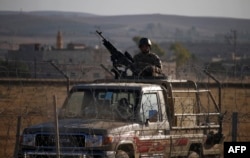 A Jordanian soldier keeps watch at the border between Syria and Jordan, near the town of Nasib in southern Syria, July 2, 2018.