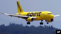 FILE - A Spirit Airlines 319 Airbus approaches Manchester Boston Regional Airport for a landing, June 2, 2023, in Manchester, N.H. Spirit has lost more than $2.5 billion since the start of 2020 and faces looming debt payments totaling more than $1 billion over the next year.