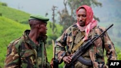 A picture taken on June 3, 2012 shows rebels of the armed force known as M23 patrolling on the hill of Kavumu in North Kivu, Democratic Republic of the Congo (DRC).
