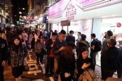 Protesters queue for a free Christmas dinner offered by a local restaurant in Hong Kong, Dec. 25, 2019.