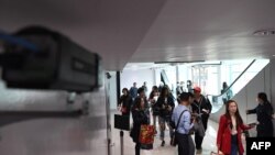 A thermal scanner monitors arriving passengers at Phnom Penh international airport in Cambodia, Jan. 22, 2020.