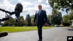 President Donald Trump talks to reporters as he walks to board Marine One on the South Lawn of the White House, Wednesday, Sept. 27, 2017, in Washington.