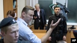Russian opposition leader Alexei Navalny gestures while speaking in a court room in Moscow, Oct. 2, 2017. A Moscow court on Monday sent Navalny to jail for 20 days for calling for an unsanctioned protest.