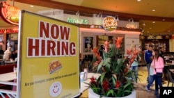 FILE - a restaurant posts a sign indicating they are hiring, in Miami.