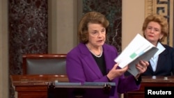 Senate Intelligence Committee Chairwoman Dianne Feinstein (D-CA) (L) discusses the newly released Intelligence Committee report on the CIA's anti-terrorism tactics, in a speech on the floor of the U.S. Senate, Dec. 9, 2014.