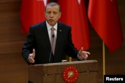 FILE - Turkish President Recep Tayyip Erdogan makes a speech during his meeting with mukhtars at the Presidential Palace in Ankara, Turkey, Nov. 26, 2015.