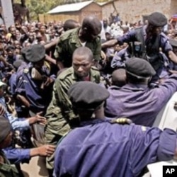 Congolese soldiers in green uniforms board a police truck after receiving their sentences in a mass rape trail in the town of Baraka, Democratic Republic of Congo (File Photo - February 27, 2011)