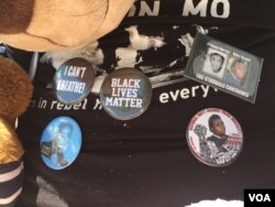 The location of Michael Brown's death on Canfield Drive in Ferguson, Missouri, is a now a makeshift memorial on the anniversary of the incident, August 11, 2015. (Victoria Macchi/VOA)