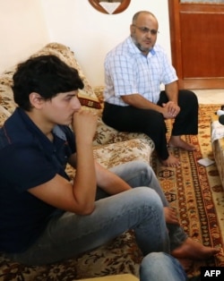 Abdul Moheman al-Raghie (L), and Nabih al-Raghie, the son and brother respectively, of al-Qaida suspect Abu Anas al-Libi speak to the press in Nofleine, five kilometres from the Libyan capital Tripoli, Oct. 6, 2013.