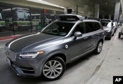 An FILE - An Uber driverless car heads out for a test drive in San Francisco, Dec. 13, 2016.