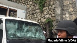 At one point in the protest, demonstrators threw rocks, damaging cars parked on the road, in Port-au-Prince, Haiti, March 29. 2019.
