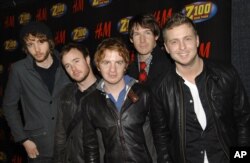 FILE - OneRepublic poses backstage at Z100's Jingle Ball