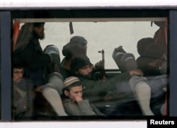 Syrian rebels are seen in the bus leaving Harasta in eastern Ghouta, in Damascus, Syria, March 23, 2018.