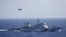 FILE - A Chinese ship and helicopter are seen during a search and rescue exercise near the Qilian Yu subgroup in the Paracel Islands, which is known in China as Xisha Islands, South China Sea, July 14, 2016.