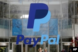 FILE - This March 10, 2015, photo shows signage outside PayPal headquarters in San Jose, Calif.