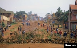 FILE - Demonstrators barricade a road during protests over their exclusion from the presidential election in Beni, Democratic Republic of Congo, Dec. 28, 2018.
