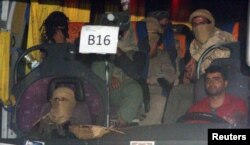 FILE - A convoy of Islamic State fighters and their families begins to depart from the Lebanon-Syria border zone in Qalamoun, Syria, Aug. 28, 2017.